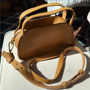 The Madewell Sydney Zip-Top Crossbody Bag (color: vintage gold)